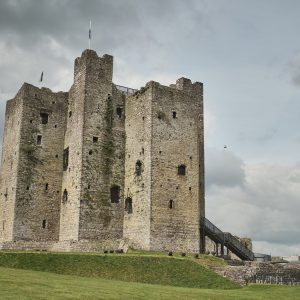 Ancient stone castle ruins under a cloudy sky.